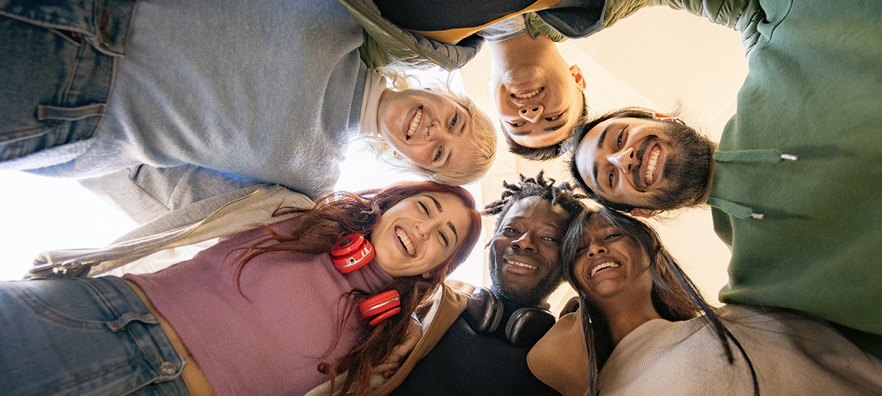 Grupo diverso de jóvenes agrupados sobre la cámara